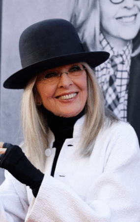 Oscar-winning actress Diane Keaton smiling in her iconic wide-brimmed hat at a Hollywood event